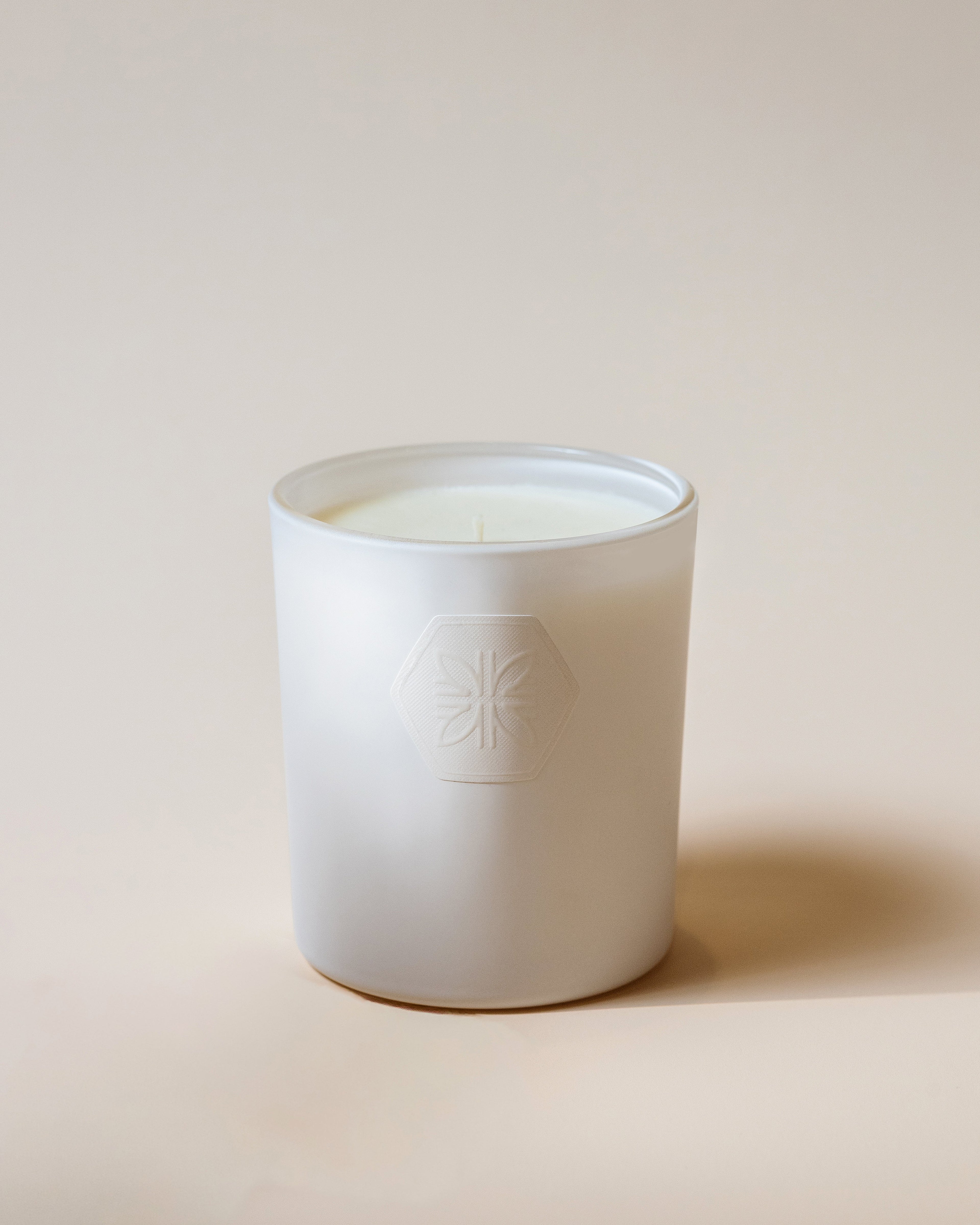 Candle held by hand and blue sky is in background
