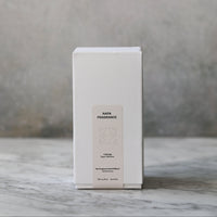 White rectangular box with text on a marble surface and gray background