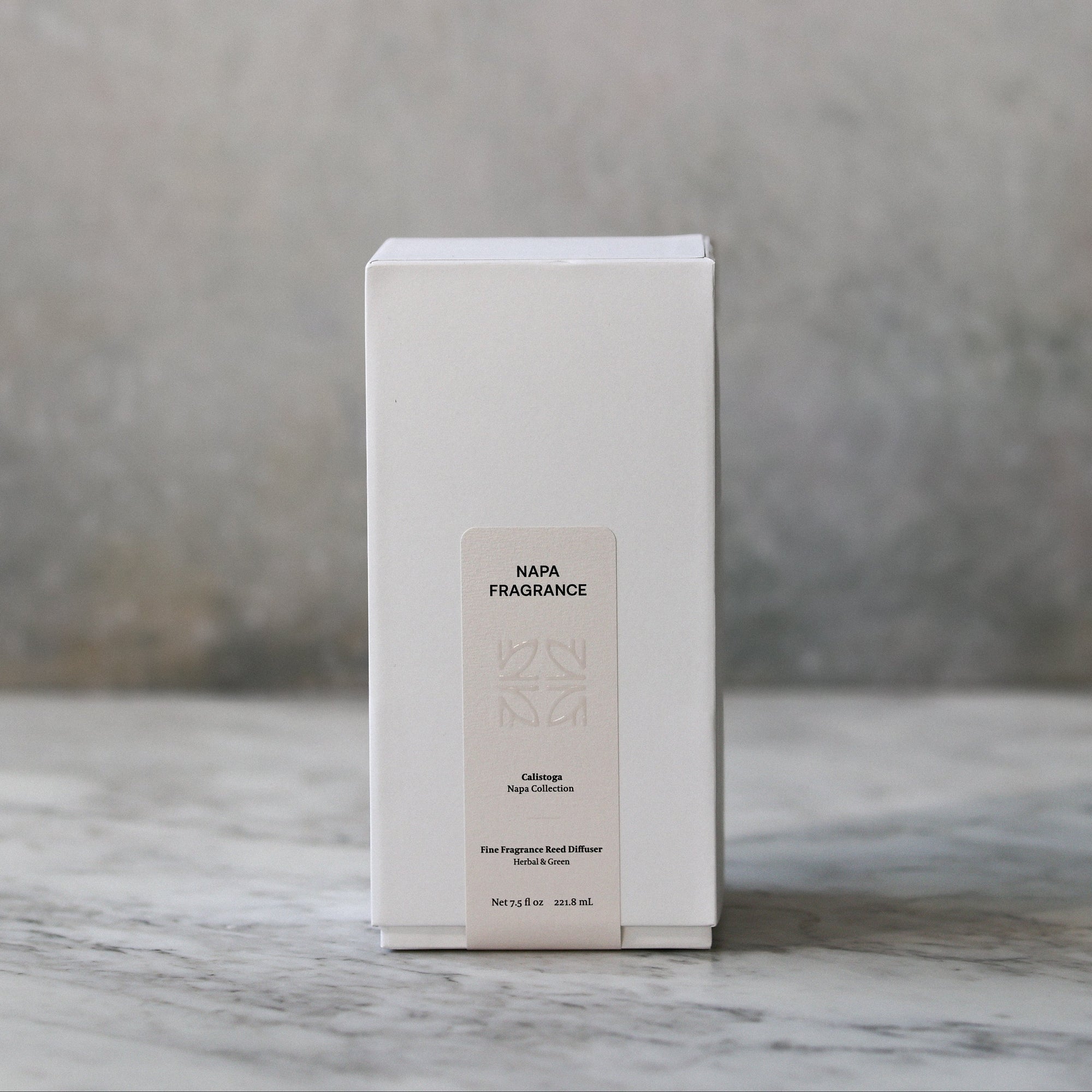White rectangular box with text on a marble surface and gray background