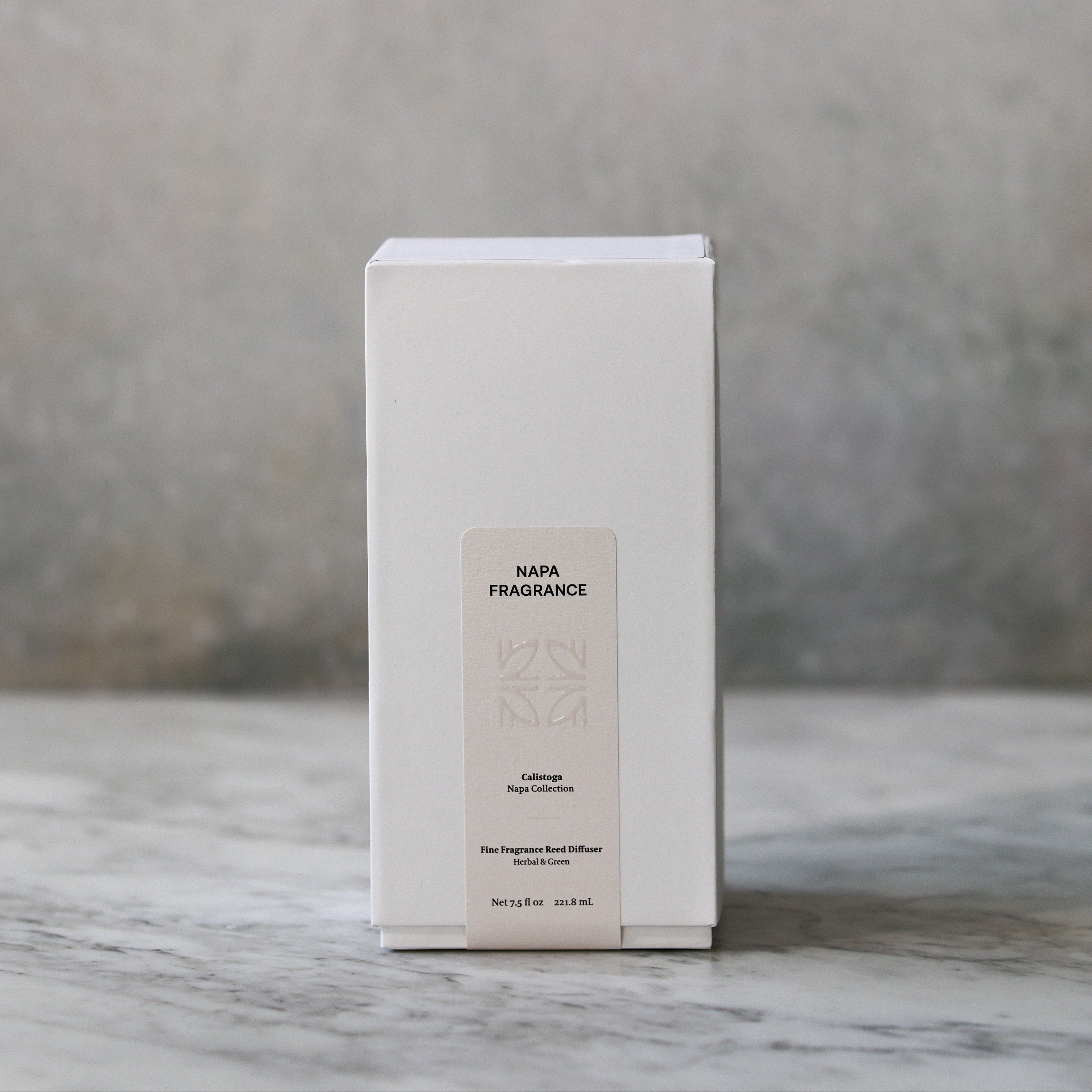 White rectangular box with text on a marble surface and gray background