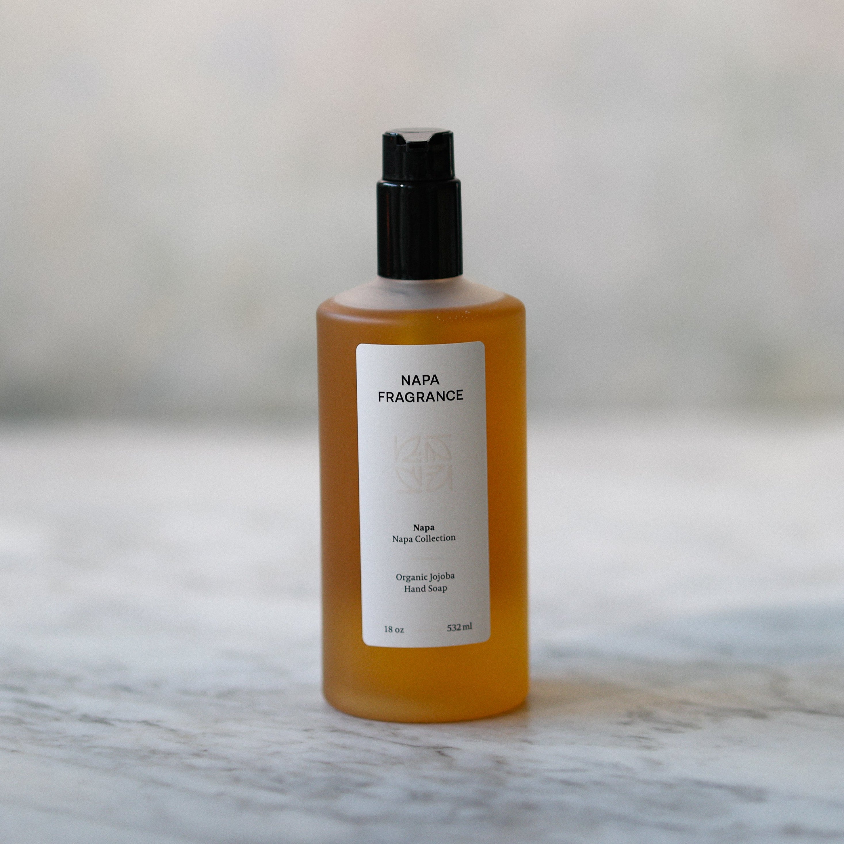 Bottle of Napa Fragrance on a marble surface with a blurred background