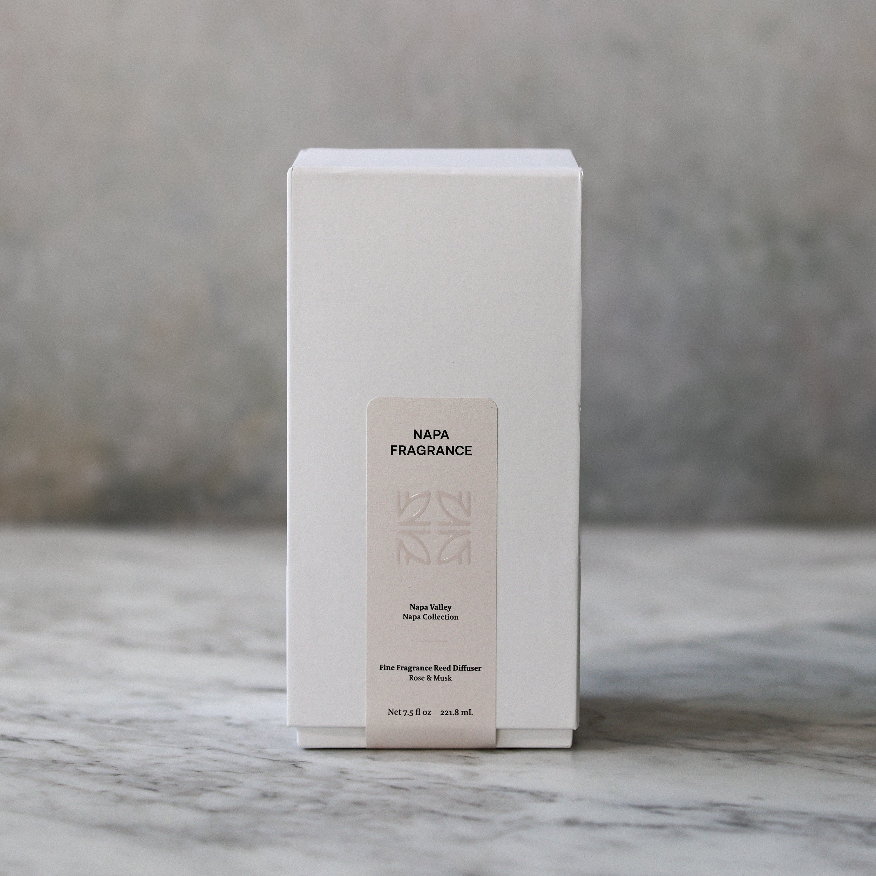 White rectangular box with a label on a marble surface and gray background