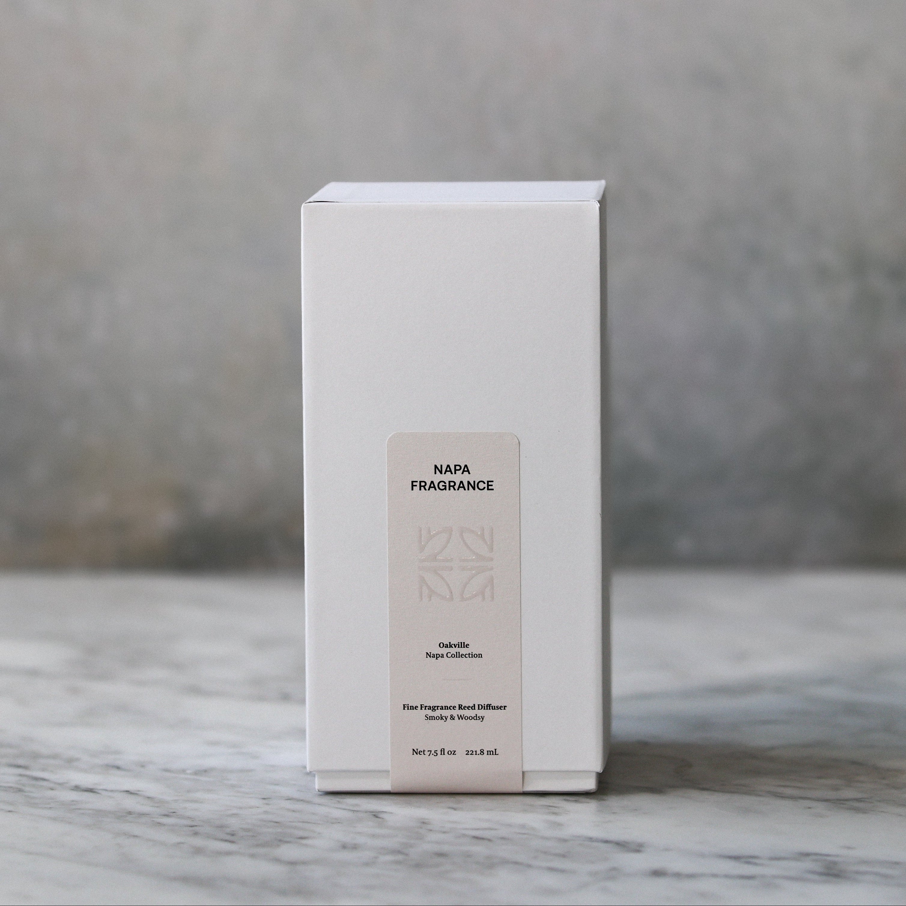 White box with a label on a marble surface and gray background