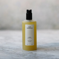 Yellow bottle with black cap on a marble surface