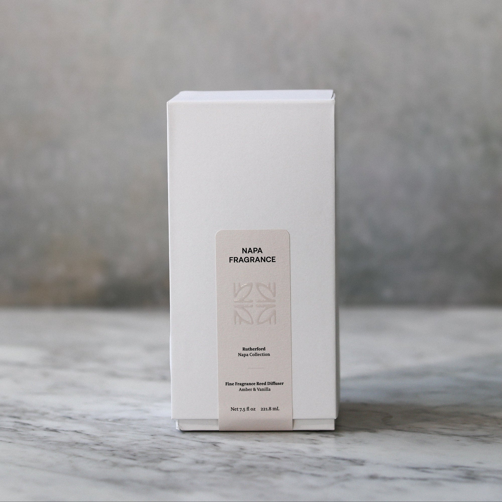 White box with a label on a marble surface and gray background