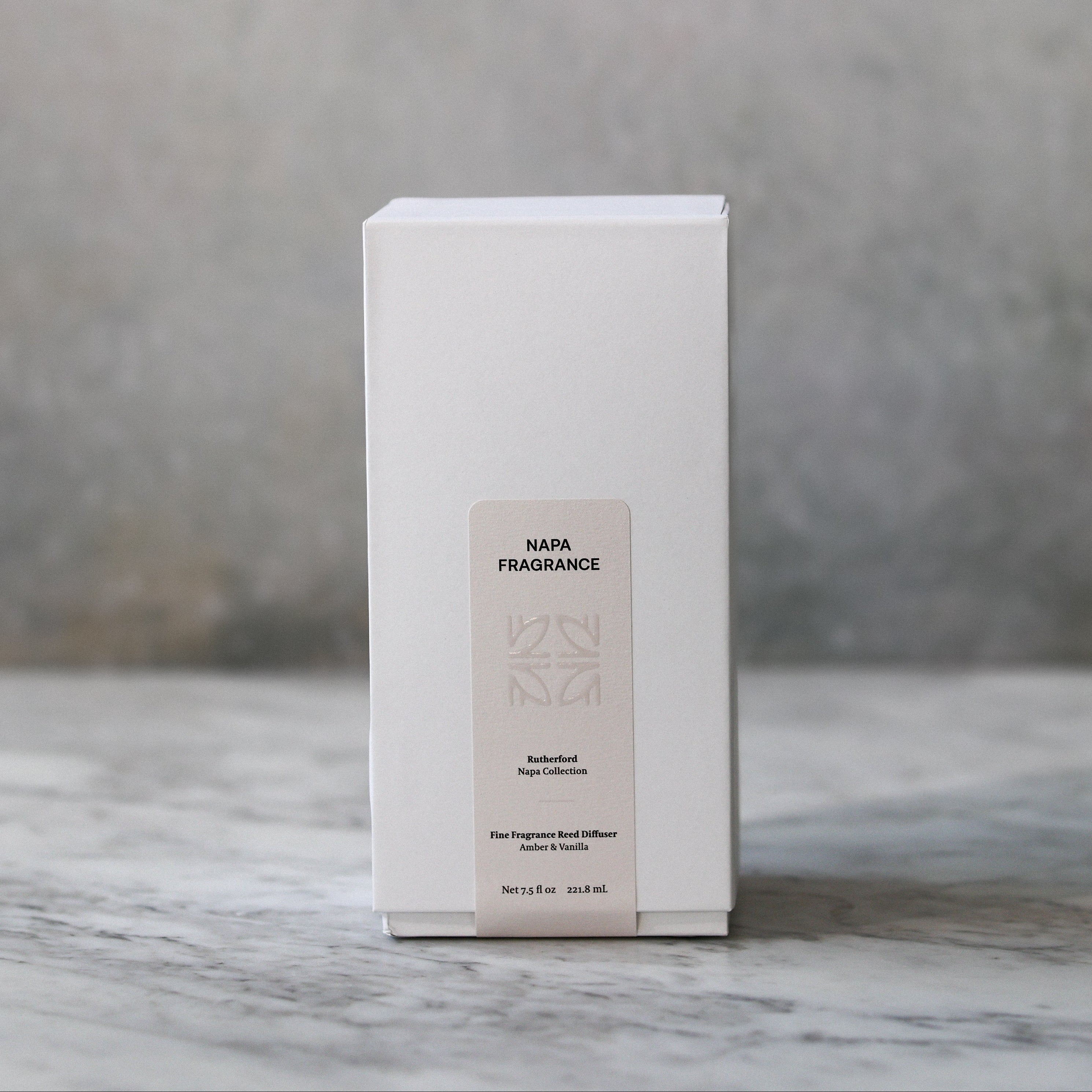 White box with a label on a marble surface and gray background
