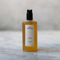 Bottle of Napa Fragrance on a marble surface with a blurred background