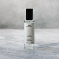 Skincare serum bottle on a marble surface with a neutral background