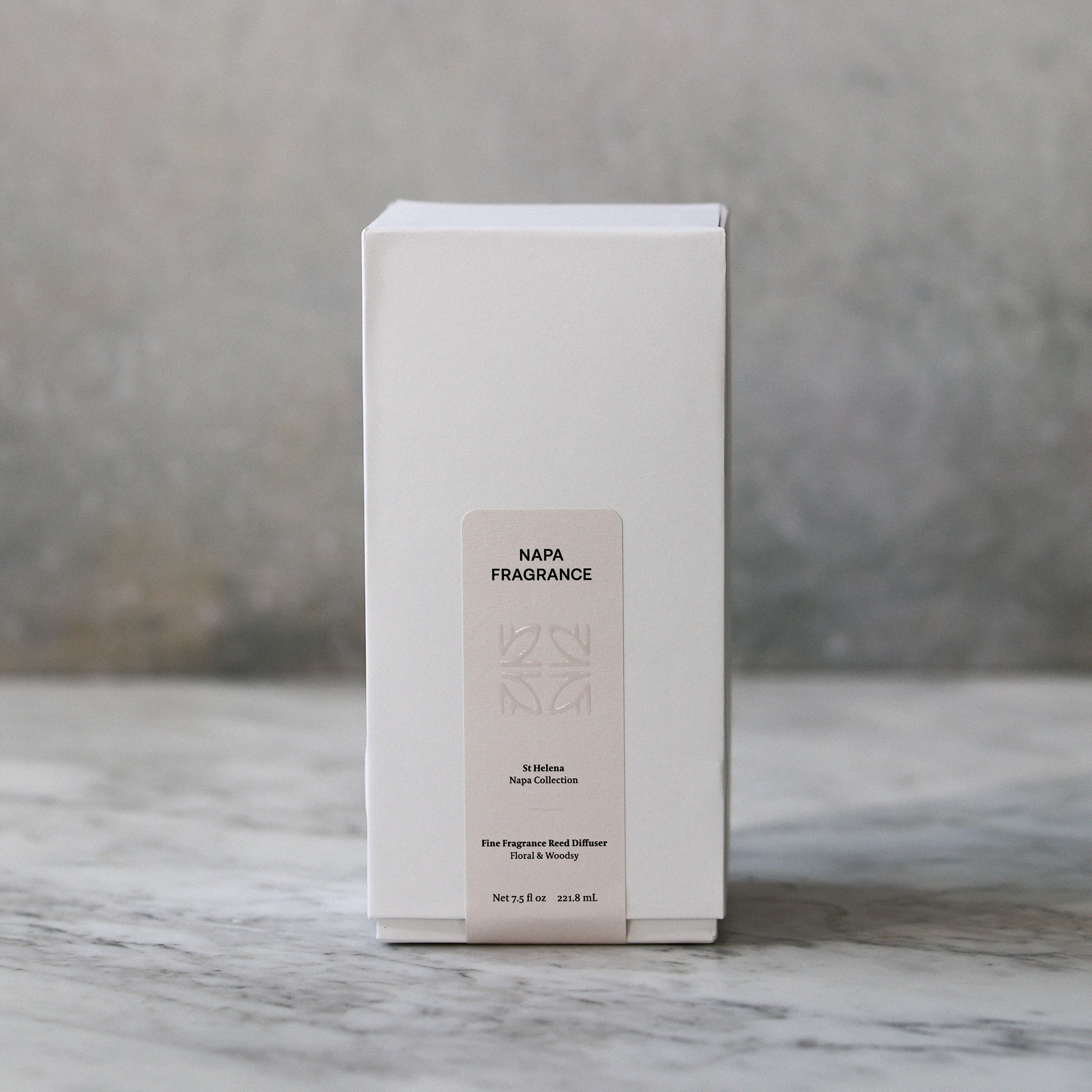 White rectangular box with text on a marble surface and gray background