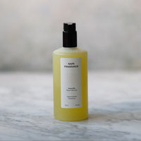 Yellow bottle with black cap on a marble surface