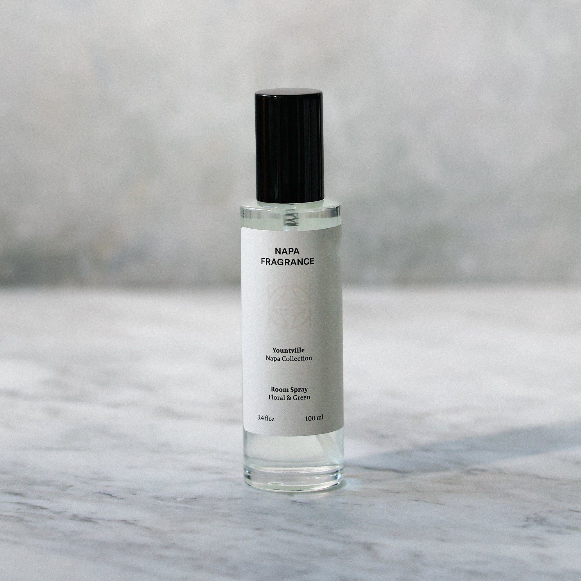 Skincare serum bottle on a marble surface with a neutral background
